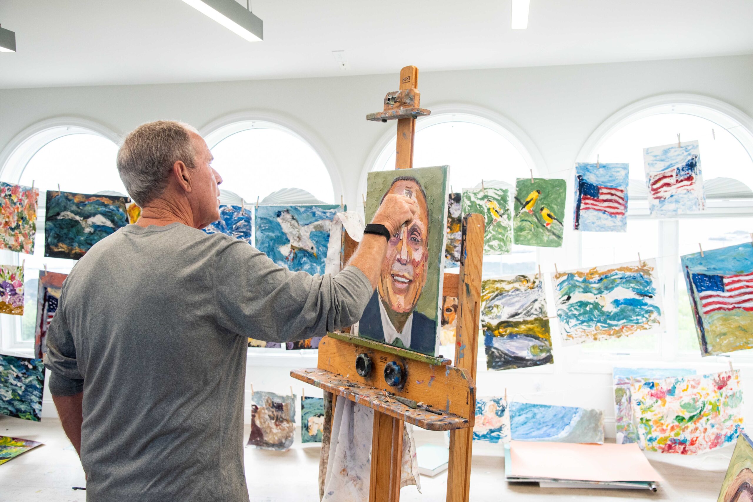 President Bush painting portraits in his studio.