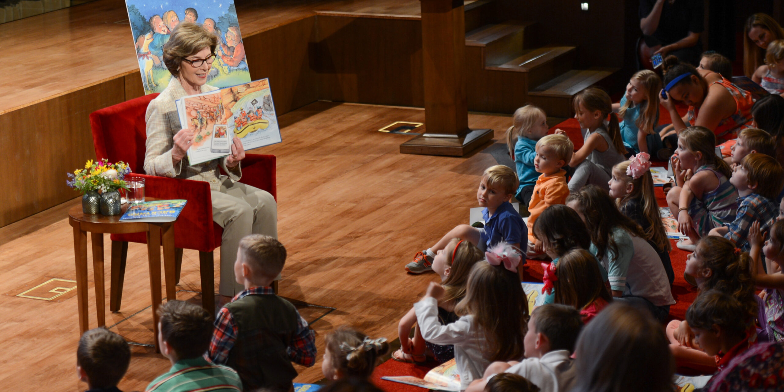 Laura Bush reading to a group of children at the Bush Center.