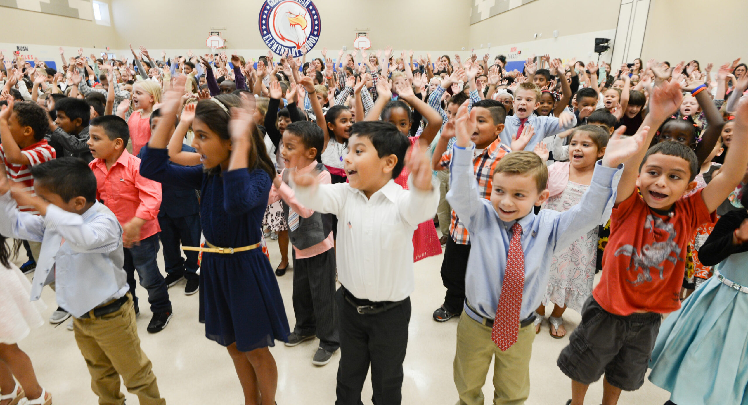 Group of students having fun in a school auditorium.
