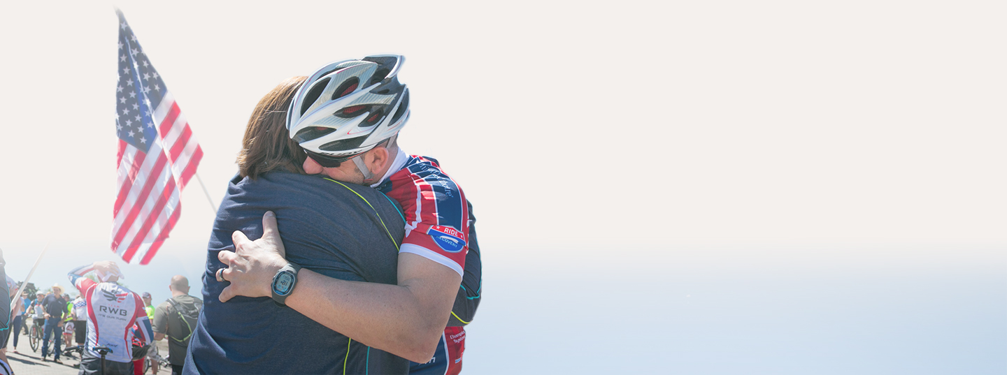President Buhs hugging a military member on the W100K.